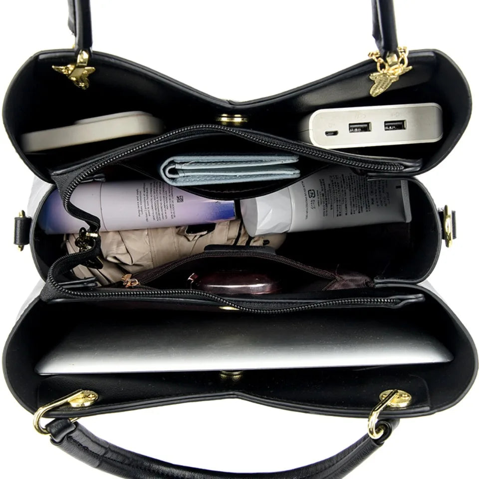 Felina™ – Elegant svart skulderveske med stilige anheng